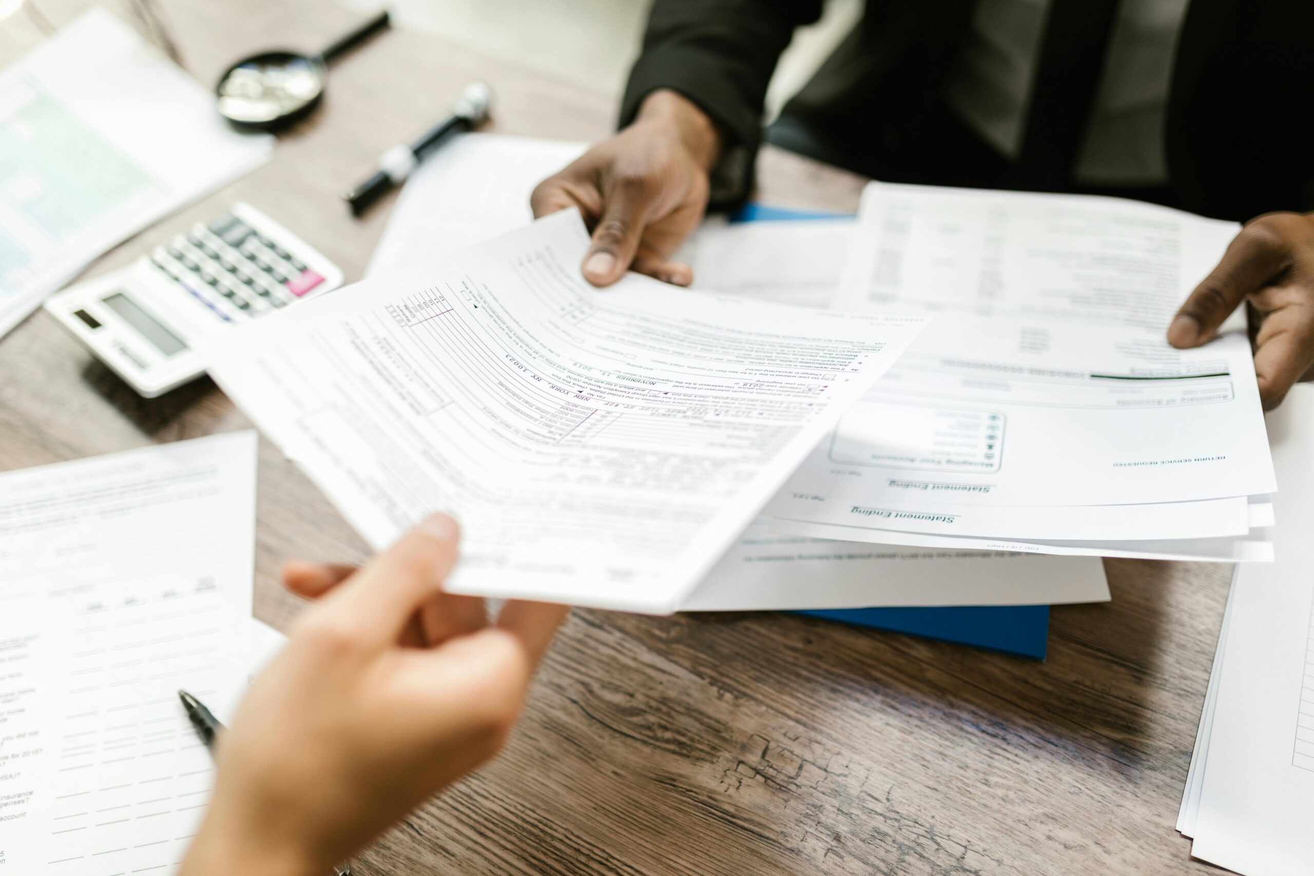 A close-up shot of travel insurance documents spread across a desk