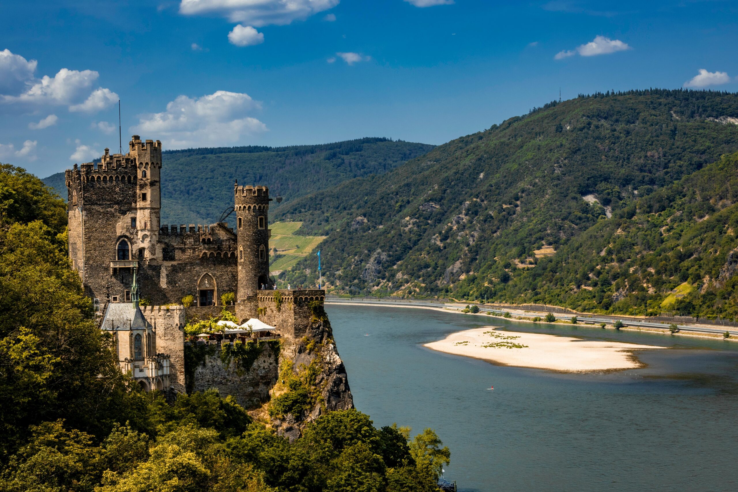 Tourists disembarking at an ancient castle along the Rhine River.