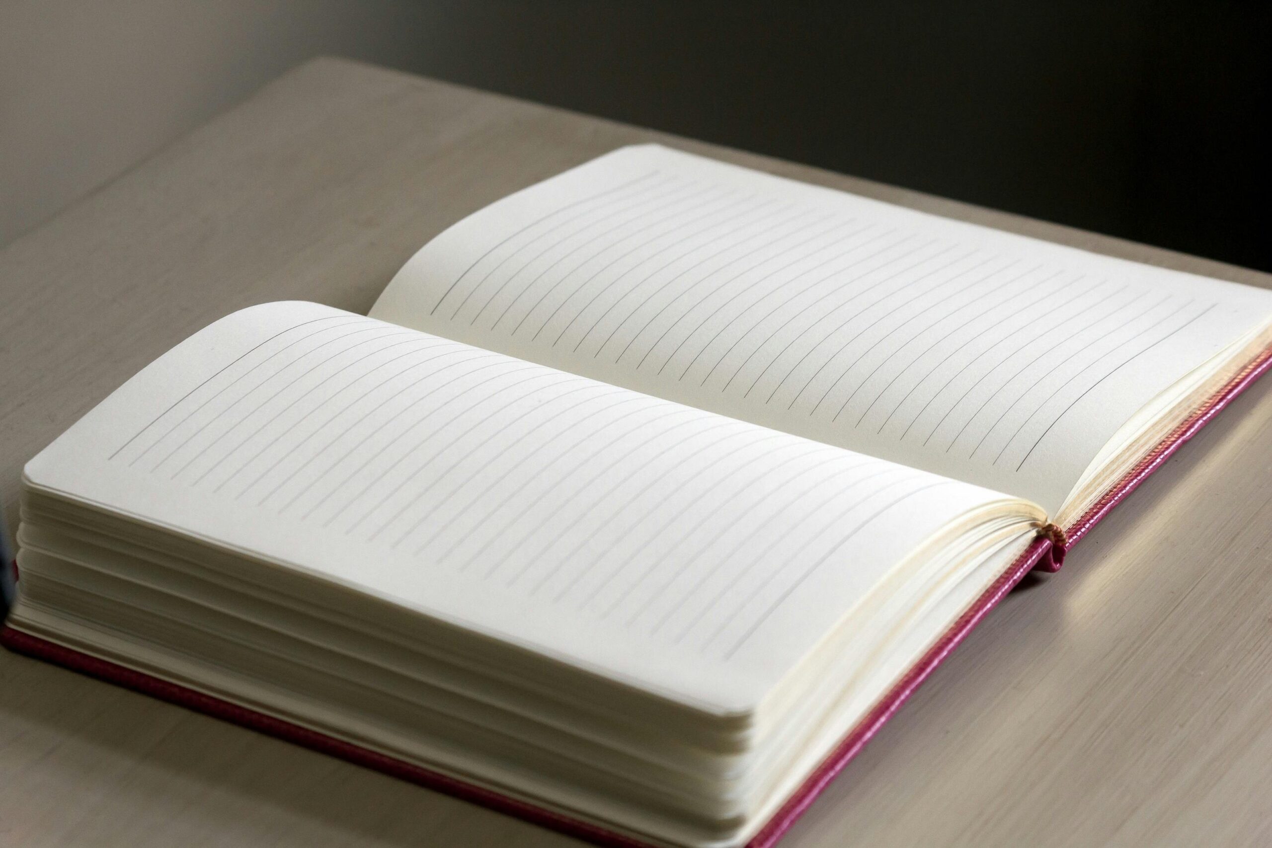 An open notebook with travel insurance documents spread across a wooden desk