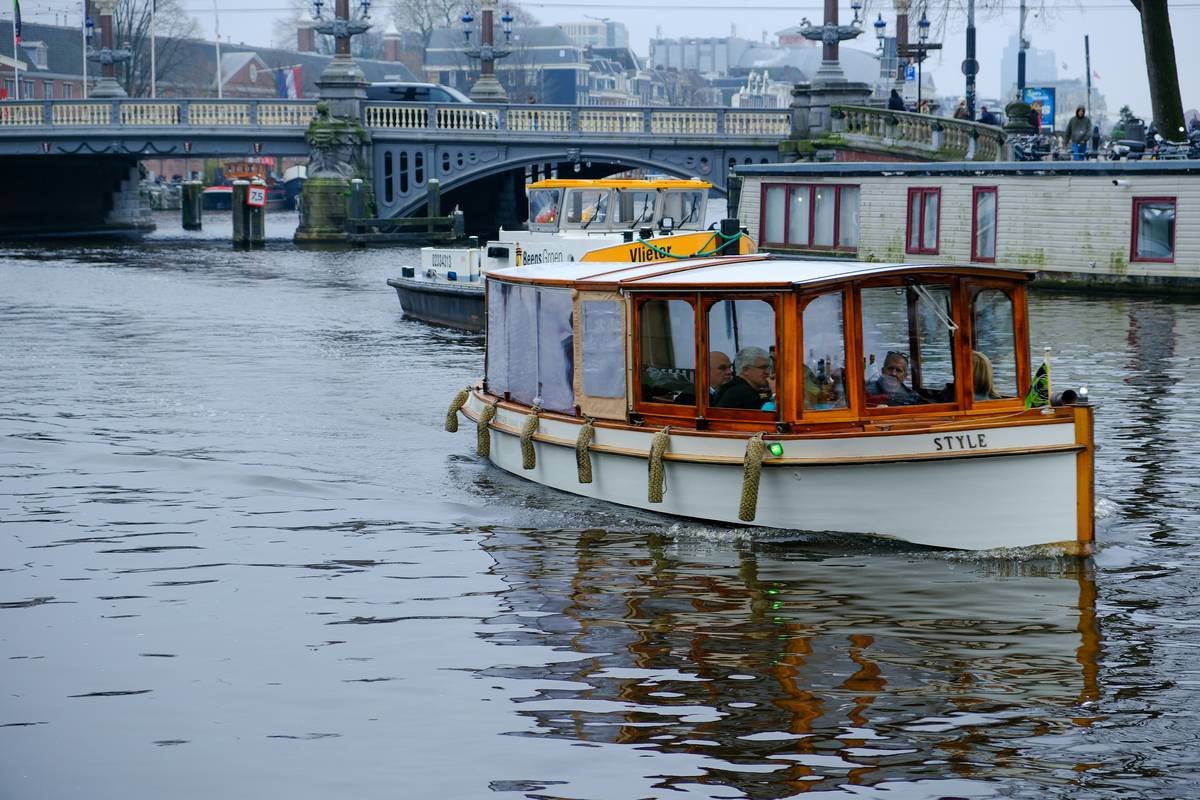 A happy traveler enjoying a drink on the deck of a river cruise ship