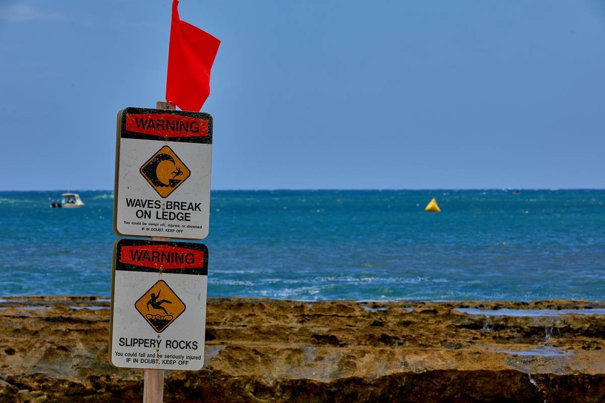 A traveler looking stressed holding a map upside down.