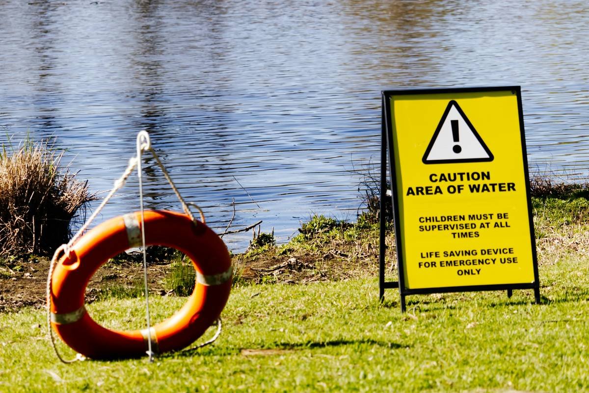 A serene riverside view during sunset with a cruise ship in the distance