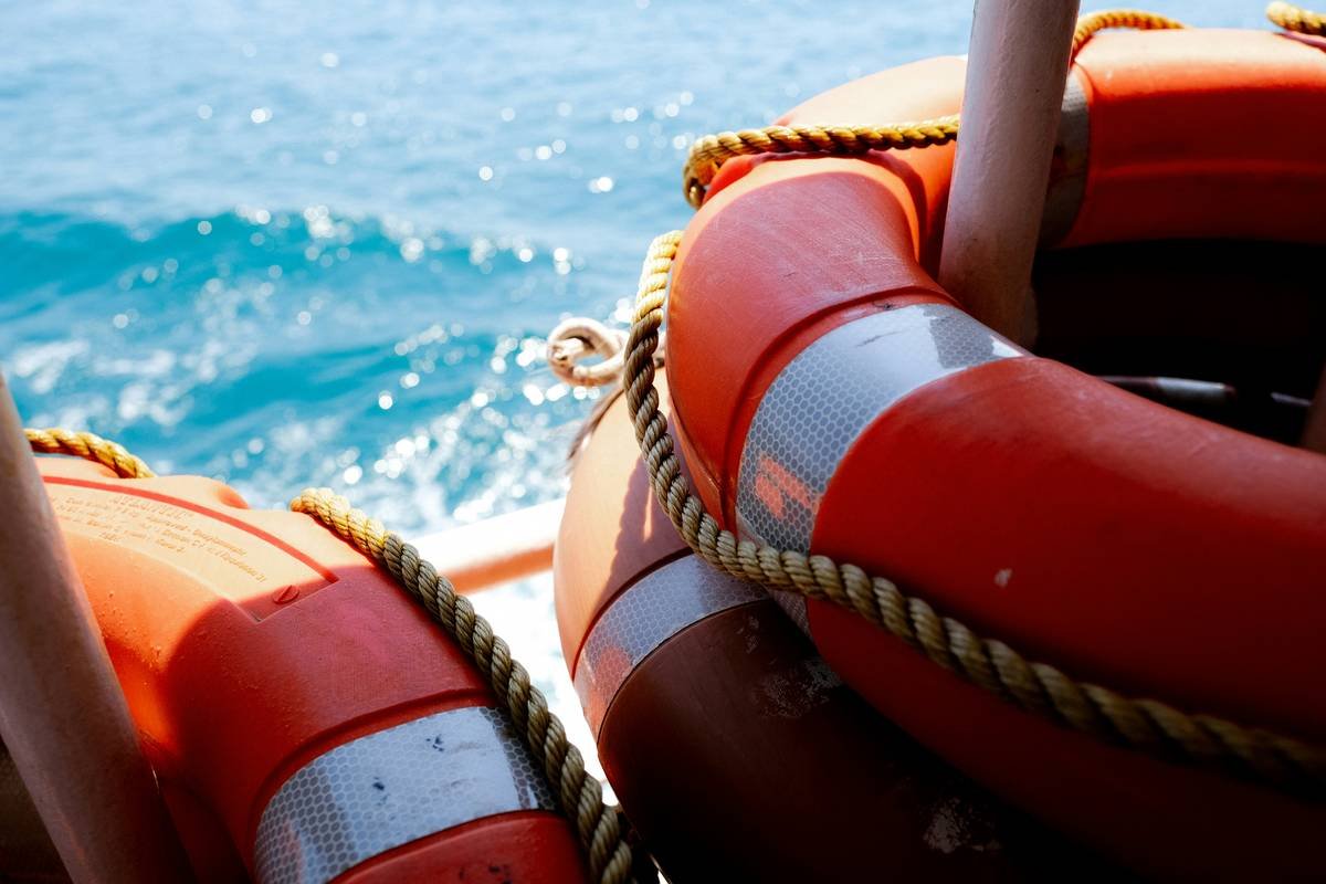a person wearing a life jacket and sitting in a boat