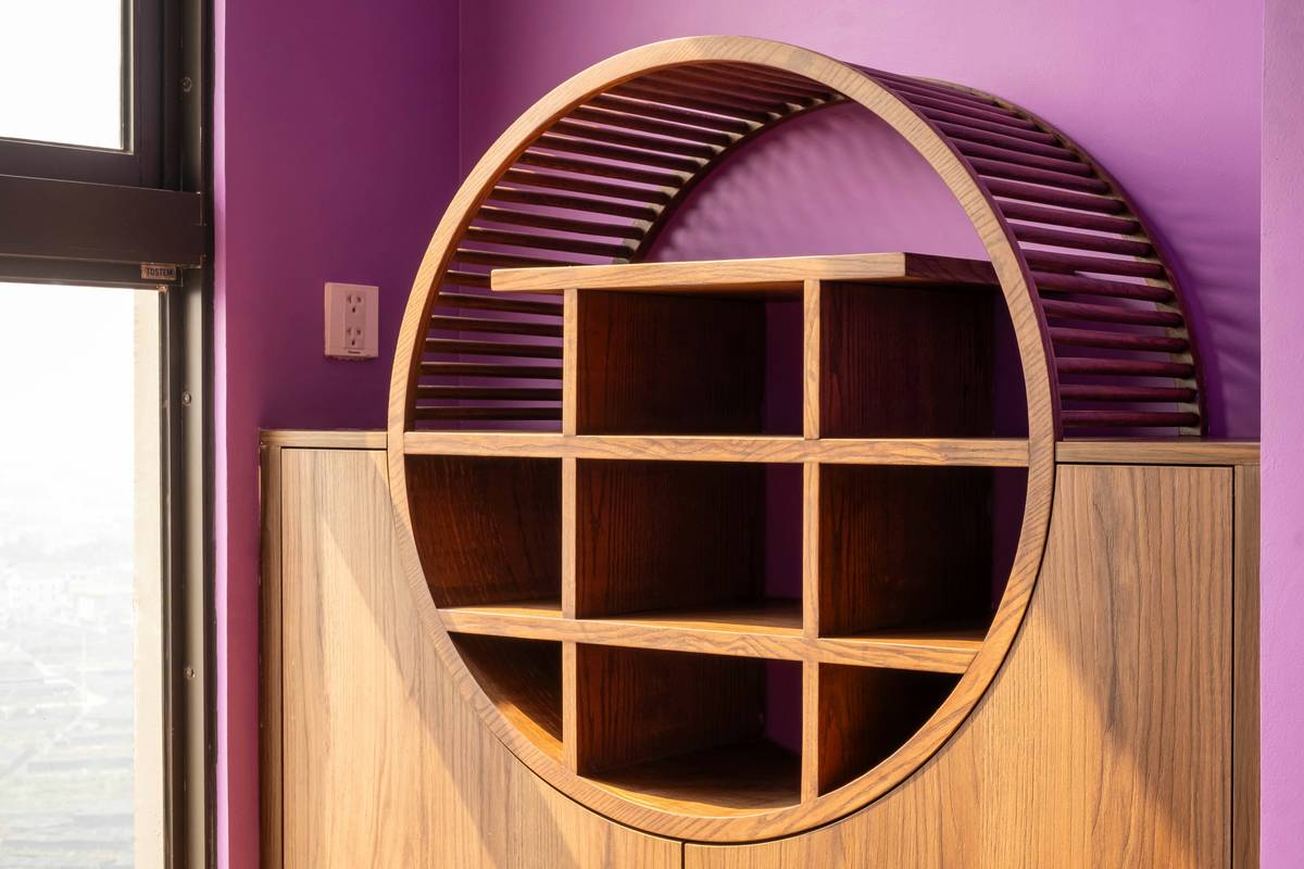 Wooden shelving unit with a unique, circular design.