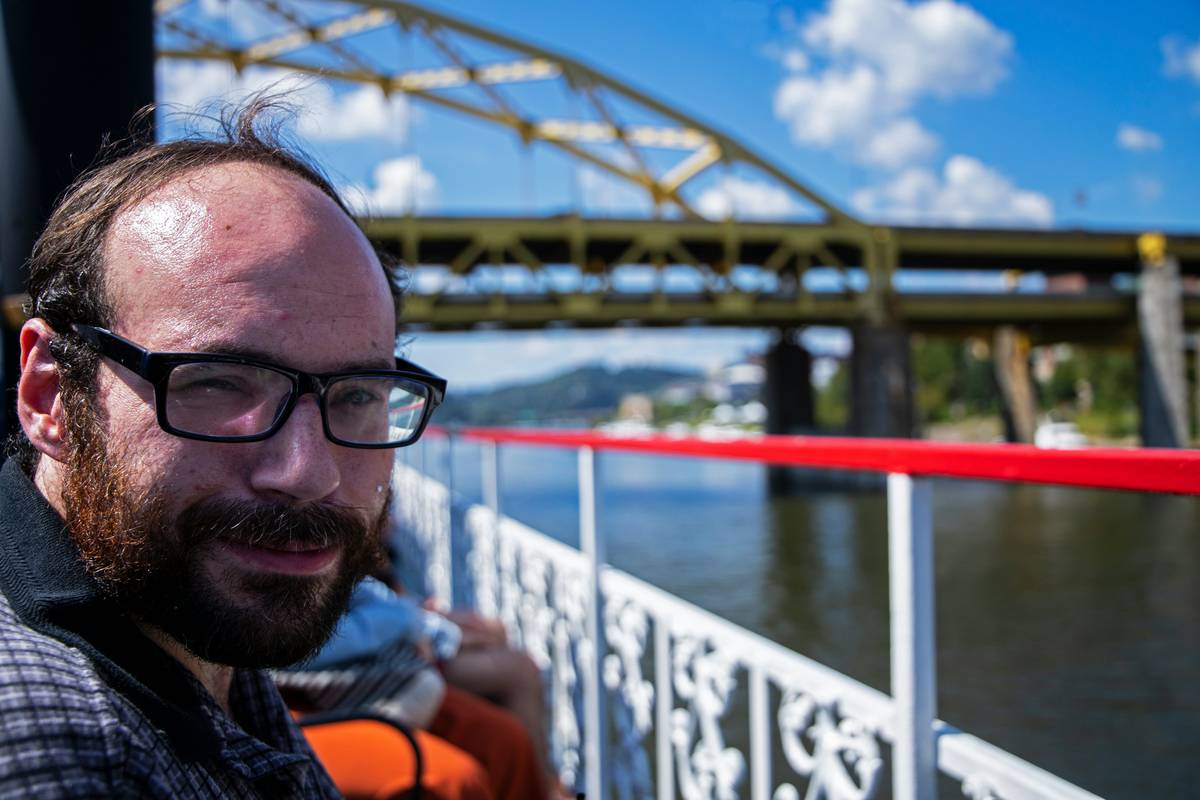 cruise guard river insurance do i: man looking stressed on riverboat deck with flooded shoreline