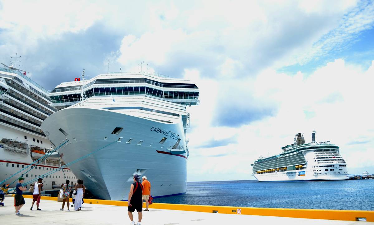 Couple reviewing medical insurance for cruising documents on riverboat deck